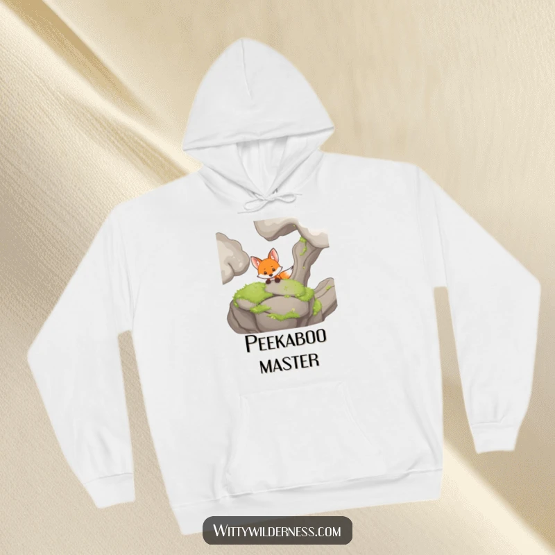 Funny hoodie featuring a curious fox peeking from behind a mossy rock, exuding playful mystery and warmth.